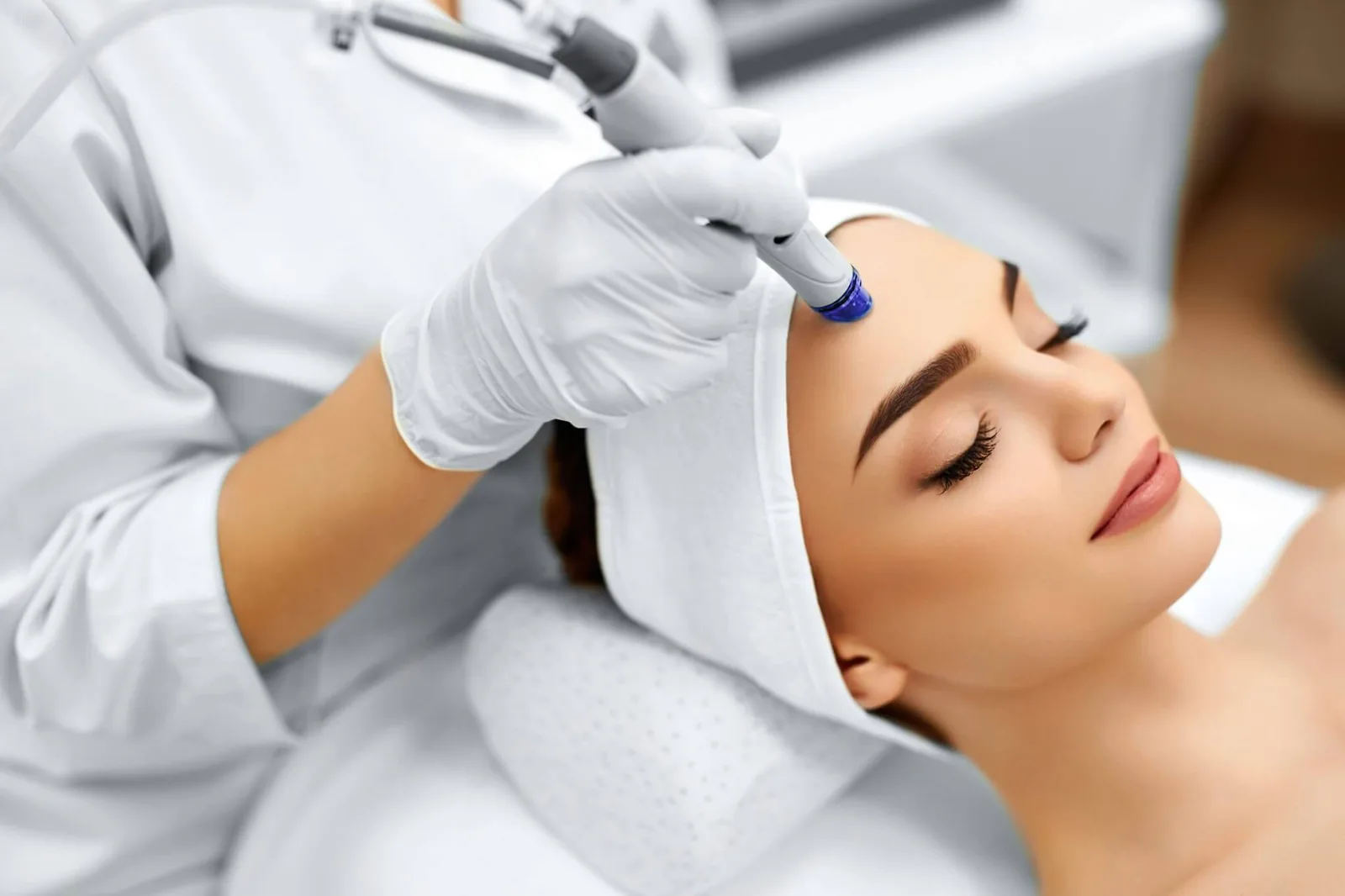 A clinician performing a facial treatment